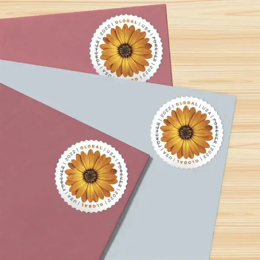 Three African daisy stamps paired with two light purple (lavender) envelopes and one Kenya green envelope, symbolizing global botanical harmony across soft and vibrant tones